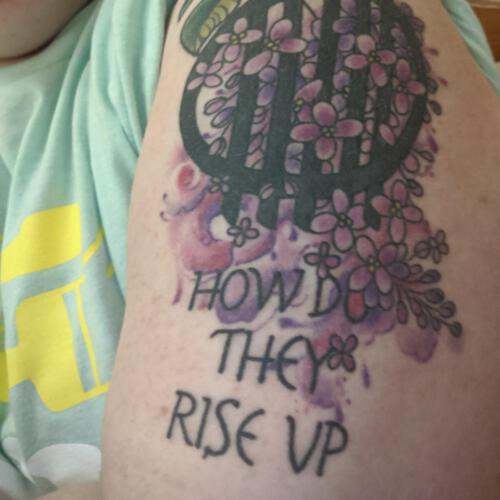 Guarding dark with lilacs. Picture taken from the Facebook group Discworld tattoos.