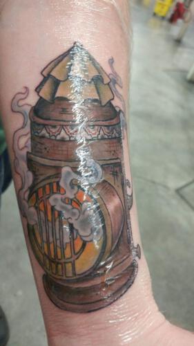 Guarding dark as a pipe. Picture taken from the Facebook group Discworld tattoos.